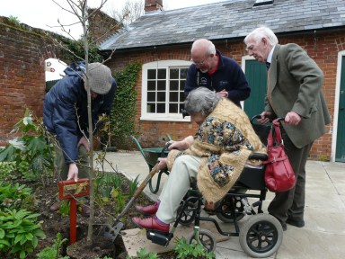 Mary and Derek Manning plant a tree to mark the opening of the garden
