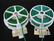 Plastic/wire twist on reel- can cut to length required and easy to use , but once fixed doesn't have much give, so not good where stems growth expected as it will effectively cut the stem unless loosened in time.
